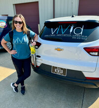 Woman standing next to the vIVid IV Mobile Clinic