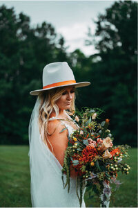 Bride in hat with bouquet
