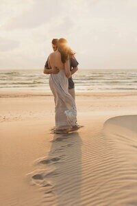 Sunset beach portrait of mother and child featured in golden hour photography tips