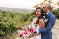 Bride and groom embrace at the Shiraz Garden wedding venue in Bastrop, Texas.
