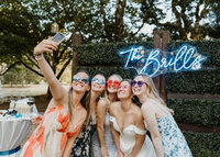 bride taking selfie with friends