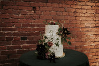 Organic wedding cake with florals by wedding planner near me