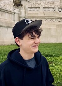 Kelly Loss's son smiles and looks into the distance