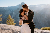 Married couple in front of Million Dollar Cowboy bar after dark in Jackson Hole Wyoming
