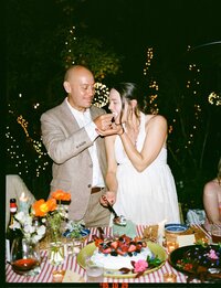 Two people celebrating at a Farm Dinner LA event in front of a rustic tablescape