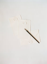 White stationery on a white surface.