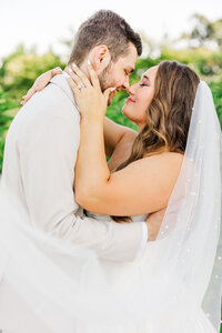bride and groom about to kiss