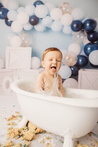 Alfie with a blue sail boat themed cakesmash photoshoot in auckland
