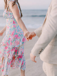 Bride and groom hand closeup during sunrise Fire Island engagement photos
