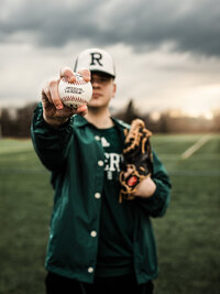 senior boy holding baseball for senior portraits