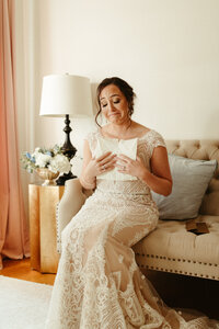 Bride crying while reading letter from groom