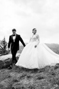 Black and white photo of couple walking together before Sundeck wedding. 