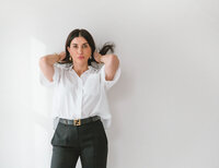 a woman standing in a natural light portrait studio