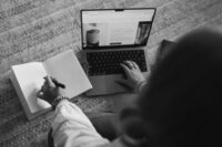 Showit website designer working on her laptop crafting a site for a fine art photographer.