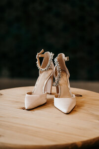 wedding shoes on a table at the pinewood weddings and events venue in Mora Minnesota taken by Lulle Photo a minneapolis wedding photographer