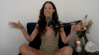 Screenshot from video coaching call of Meg O'Neill sitting in chair with a microphone