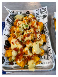 Tater tots with queso and bacon