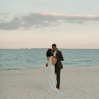 The bride and groom did their sunset portraits on the beach in Cancun, Mexico. The sky was the most beautiful shade of pink and blue.