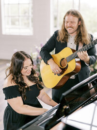 Mikaela Kahn live event vocalist playing piano while her husband Jordan plays guitar