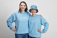 two teenage girls wearing blue sweatshirts