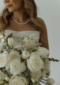 close bridal portrait of bride holding her bouquet 