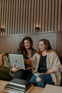 women posing on couch