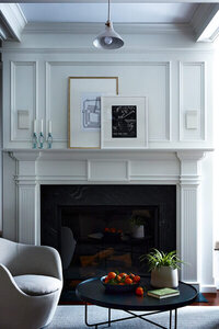Interior decorators in Boston design a traditional Concord home with modern furniture, featuring Design Within Reach swivel chairs for a refined, balanced look.