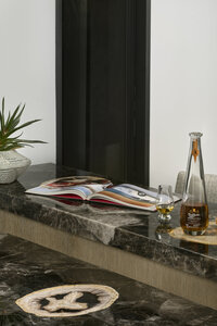 JSF Design custom bar top with artisanal finish and curated alcohol display