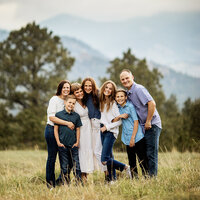 Family Photographer, family of 7 standing together in grassy field