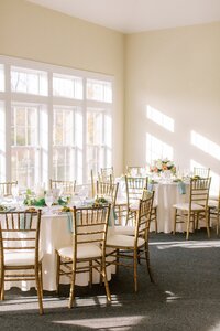 Ballroom wedding reception with green and gold