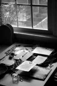 Black and white photo of a flatlay of one of Amy's luxury wedding paper suites in the sunlight