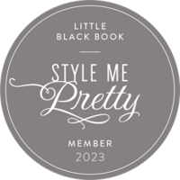 Round grey badge with the text "LITTLE BLACK BOOK – STYLE ME PRETTY – MEMBER 2023" in white, ornate lettering, perfect for showcasing your credentials as a full service wedding planner.