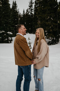 couple stands in snow