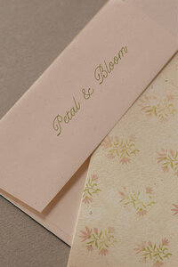 a pink envelope and a printed floral card