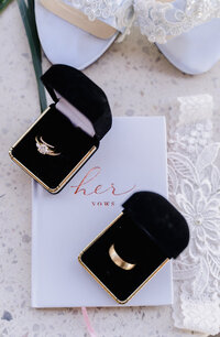 Wedding rings and vow book on wedding day