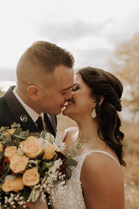 Bride and groom leaning in to kiss