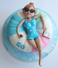 summer pool float cake, woman floating on pool float cake