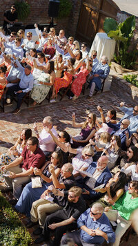 A group photo of guests sitting together during the wedding ceremony