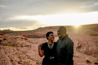 A couple sharing an unforgettable engagement moment at the edge of Lake Powell, with the reflective waters perfectly mirroring the surrounding cliffs.