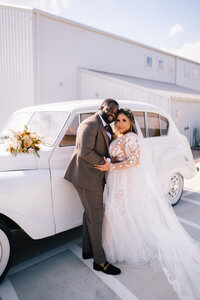 Sacramento Wedding Photographer captures couple standing along vintage car