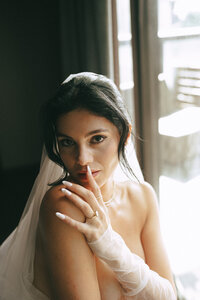 woman holding her hand to her face