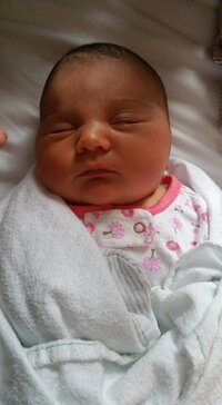 newborn baby girl wrapped in a blanket