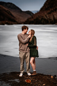 couple looks at eachother in adirondacks ny near cascade lakes 