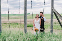 A bride stands with her bridesmaids in some trees.
