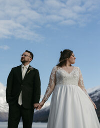 A couple holding hands and feeling the sunshine on their faces.