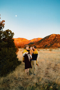Experience the exceptional work of a top-rated Albuquerque photographer for families with this touching image of a beautiful mom in a white long vintage dress, embracing her daughter.