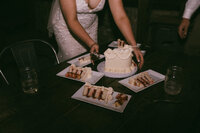 A couple standing close and laughing on a foggy dirt road 