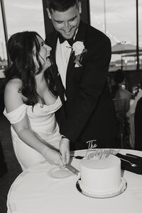 engaged couple with girl laughing as guy kisses her on the cheek