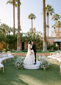 Bride and groom share their first kiss during their wedding ceremony at Royal Palms Wedding Venue in Scottsdale, Arizona.