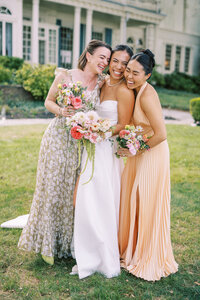 Maids of honor hug bride at Glen Foerd Estate in Philadelphia, PA